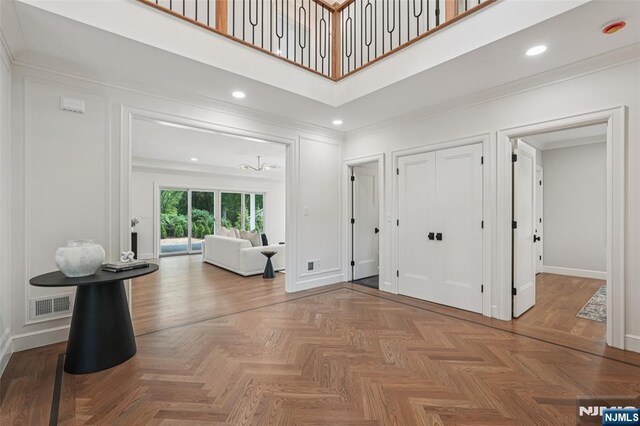 107 Rutland Rd, Glen Rock, NJ 07452 - entryway with ornamental molding, baseboards, a towering ceiling, and recessed lighting