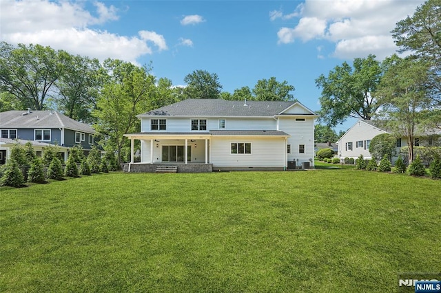 107 Rutland Rd, Glen Rock, NJ 07452 - back of house with a porch and a lawn
