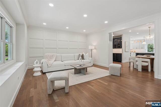 107 Rutland Rd, Glen Rock, NJ 07452 - living room with wood finished floors, baseboards, crown molding, and recessed lighting