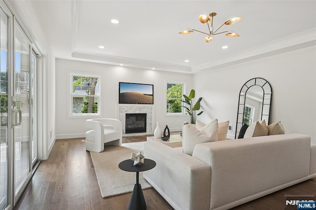 107 Rutland Rd, Glen Rock, NJ 07452 - living room featuring a raised ceiling, a chandelier, a fireplace, wood finished floors, and crown molding