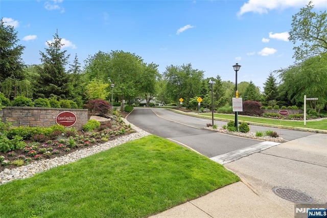 32 Mallard Ct, Englewood, NJ 07631 - view of asphalt road with traffic signs, street lights, sidewalks, and curbs