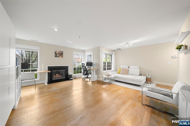 32 Mallard Ct, Englewood, NJ 07631 - living room featuring light wood finished floors, a fireplace with flush hearth, recessed lighting, and baseboards
