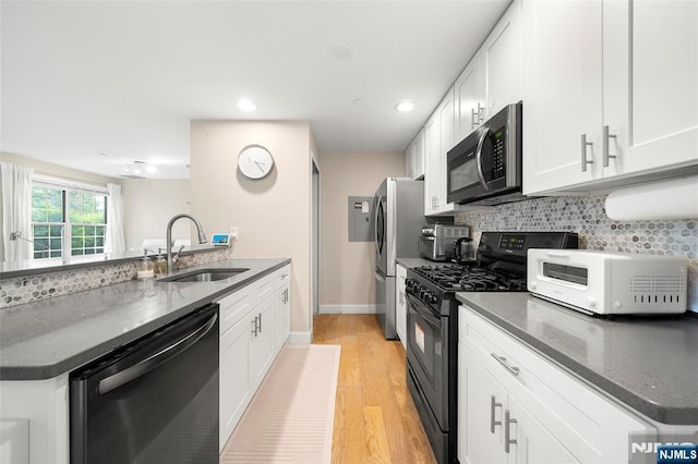 32 Mallard Ct, Englewood, NJ 07631 - kitchen featuring stainless steel appliances, a sink, white cabinets, and recessed lighting