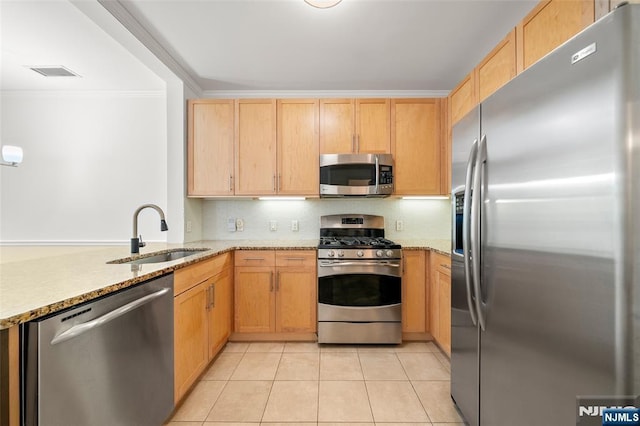 3326 Riverview Ave Unit 326, Englewood, NJ 07631 - kitchen with appliances with stainless steel finishes, a sink, light tile patterned floors, tasteful backsplash, and light stone counters