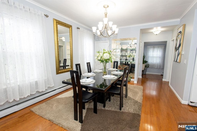 332 Summer St, Clifton, NJ 07011 - dining area with baseboard heating, a chandelier, wood finished floors, and ornamental molding