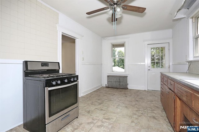 267 Hoover Ave, Bloomfield, NJ 07003 - kitchen with stainless steel range with gas cooktop, radiator, brown cabinetry, a ceiling fan, and light countertops