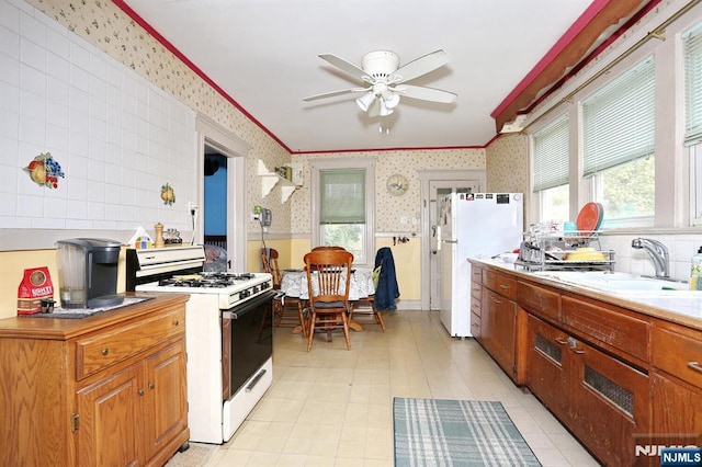267 Hoover Ave, Bloomfield, NJ 07003 - kitchen with wallpapered walls, white appliances, a sink, ceiling fan, and ornamental molding