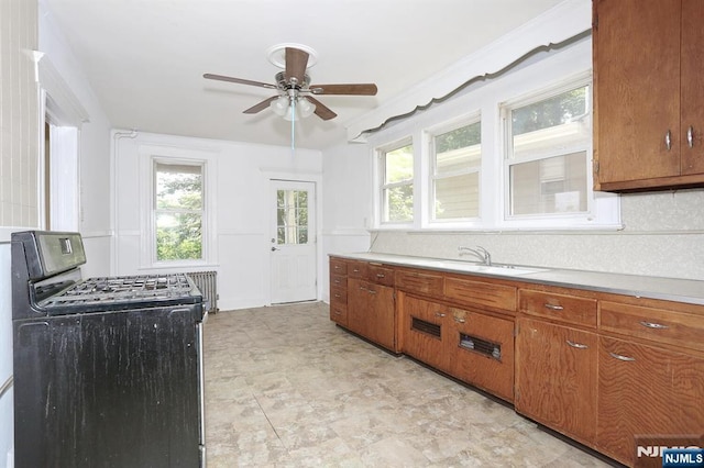 267 Hoover Ave, Bloomfield, NJ 07003 - kitchen featuring gas range, a ceiling fan, brown cabinets, and light countertops