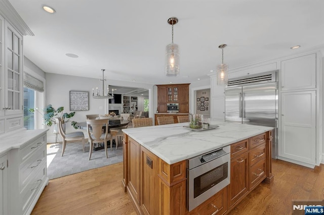 43 Heights Rd, Allendale, NJ 07401 - kitchen with built in appliances, glass insert cabinets, brown cabinetry, light wood finished floors, and recessed lighting