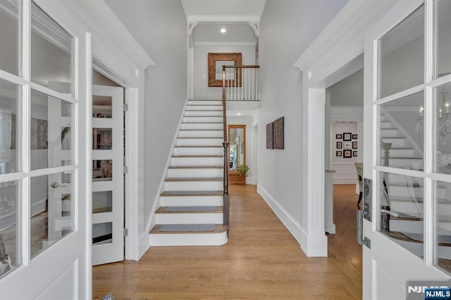 43 Heights Rd, Allendale, NJ 07401 - entrance foyer featuring stairs, a high ceiling, light wood-style flooring, french doors, and crown molding