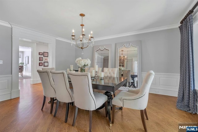 43 Heights Rd, Allendale, NJ 07401 - dining space featuring a chandelier, ornamental molding, wood finished floors, a wainscoted wall, and a decorative wall