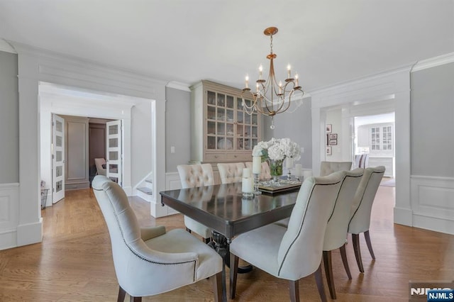43 Heights Rd, Allendale, NJ 07401 - dining area featuring a chandelier, a decorative wall, crown molding, wood finished floors, and wainscoting