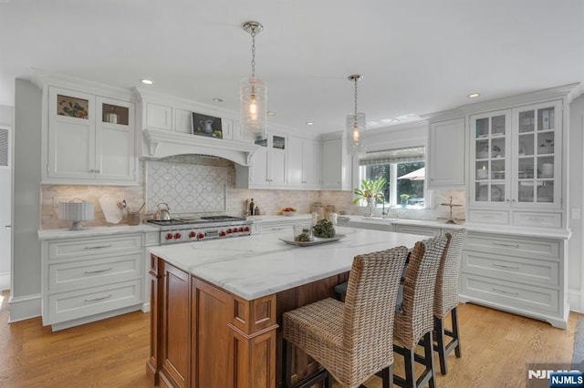 43 Heights Rd, Allendale, NJ 07401 - kitchen with a center island, white cabinets, light wood-style flooring, backsplash, and recessed lighting