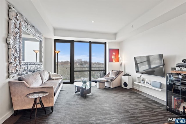 320 Adolphus Ave Unit 702, Cliffside Park, NJ 07010 - living area with a wall of windows, a tray ceiling, baseboards, and carpet floors