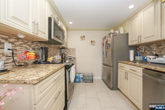 8841 Kennedy Unit 19, North Bergen, NJ 07047 - kitchen with stainless steel appliances, cream cabinets, tasteful backsplash, light tile patterned floors, and light stone countertops
