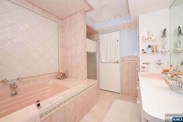 8841 Kennedy Unit 19, North Bergen, NJ 07047 - full bath featuring a garden tub, tile patterned flooring, tile walls, and vanity