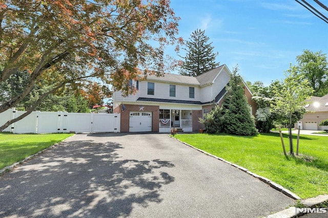 57 Eckerson Ave, Closter, NJ 07624 - traditional home featuring a gate, driveway, brick siding, and an attached garage