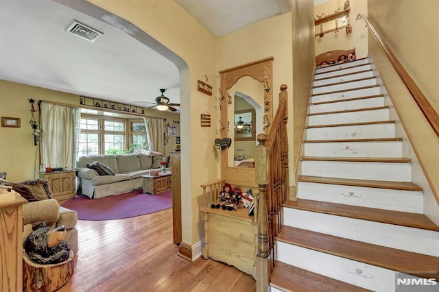 57 Eckerson Ave, Closter, NJ 07624 - stairs with arched walkways, ceiling fan, and hardwood / wood-style flooring