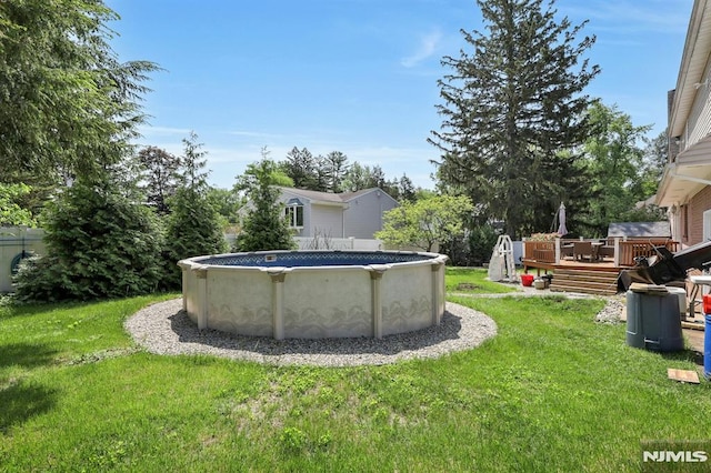 57 Eckerson Ave, Closter, NJ 07624 - view of grassy yard featuring a wooden deck and an outdoor pool