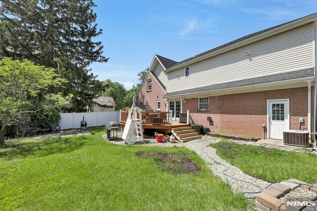 57 Eckerson Ave, Closter, NJ 07624 - back of property with brick siding, a wooden deck, and central air condition unit