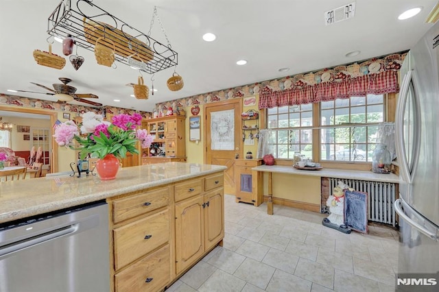 57 Eckerson Ave, Closter, NJ 07624 - kitchen featuring appliances with stainless steel finishes, radiator heating unit, light countertops, a ceiling fan, and light tile patterned floors