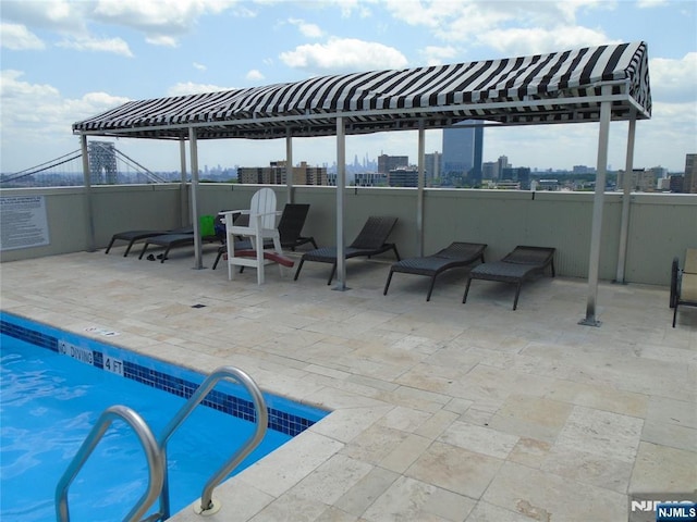 1 Wall St Unit 8-C, Fort Lee, NJ 07024 - community pool with a view of skyline and a patio area