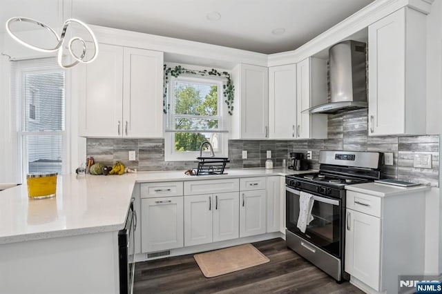 31 Vanderbeck Pl, Hackensack, NJ 07601 - kitchen with stainless steel gas range, wall chimney exhaust hood, a sink, and white cabinetry