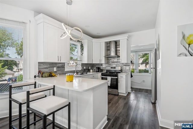 31 Vanderbeck Pl, Hackensack, NJ 07601 - kitchen featuring stainless steel range with gas stovetop, wall chimney exhaust hood, a peninsula, and healthy amount of natural light