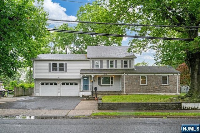 310 Spring Valley Rd, Paramus, NJ 07652 - view of front of house with a garage, asphalt driveway, and covered porch