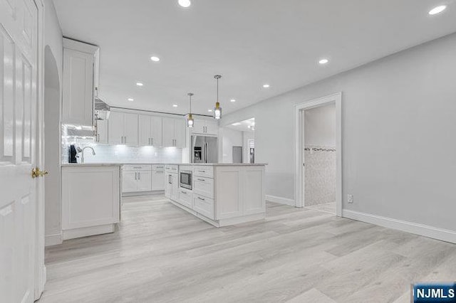 310 Spring Valley Rd, Paramus, NJ 07652 - kitchen with appliances with stainless steel finishes, white cabinetry, light wood-style floors, recessed lighting, and pendant lighting
