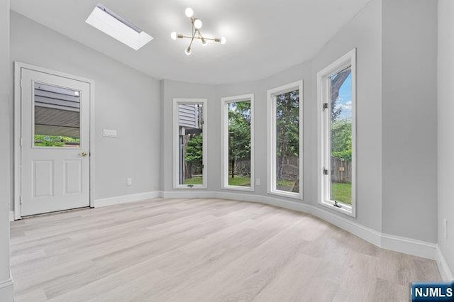 310 Spring Valley Rd, Paramus, NJ 07652 - unfurnished room with plenty of natural light, light wood-type flooring, baseboards, and vaulted ceiling