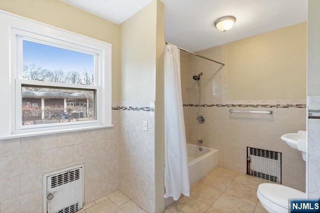 310 Spring Valley Rd, Paramus, NJ 07652 - full bathroom with radiator heating unit, tile walls, toilet, shower / bath combination with curtain, and tile patterned floors