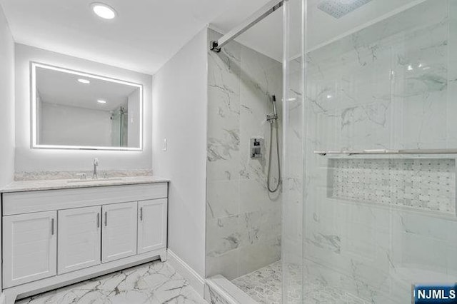 310 Spring Valley Rd, Paramus, NJ 07652 - bathroom featuring marble look tile flooring, vanity, a marble finish shower, recessed lighting, and baseboards