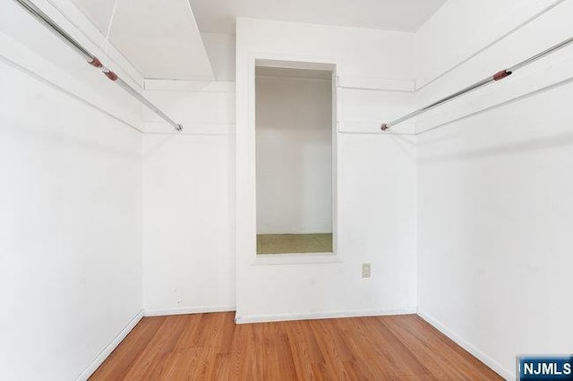 310 Spring Valley Rd, Paramus, NJ 07652 - walk in closet featuring wood finished floors