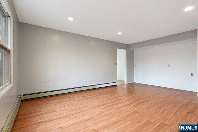 310 Spring Valley Rd, Paramus, NJ 07652 - empty room with a baseboard radiator, baseboard heating, light wood-style flooring, and recessed lighting