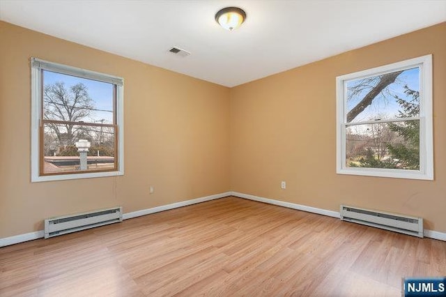 310 Spring Valley Rd, Paramus, NJ 07652 - empty room featuring a baseboard heating unit, wood finished floors, and baseboards