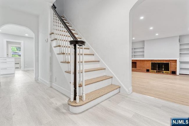 310 Spring Valley Rd, Paramus, NJ 07652 - staircase with arched walkways, wood finished floors, recessed lighting, baseboards, and radiator