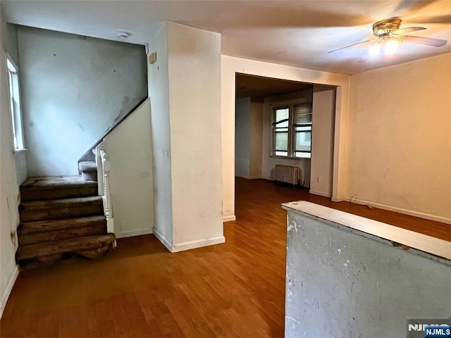 22 Clark St, Glen Ridge, NJ 07028 - unfurnished living room featuring radiator, ceiling fan, wood finished floors, stairway, and baseboards