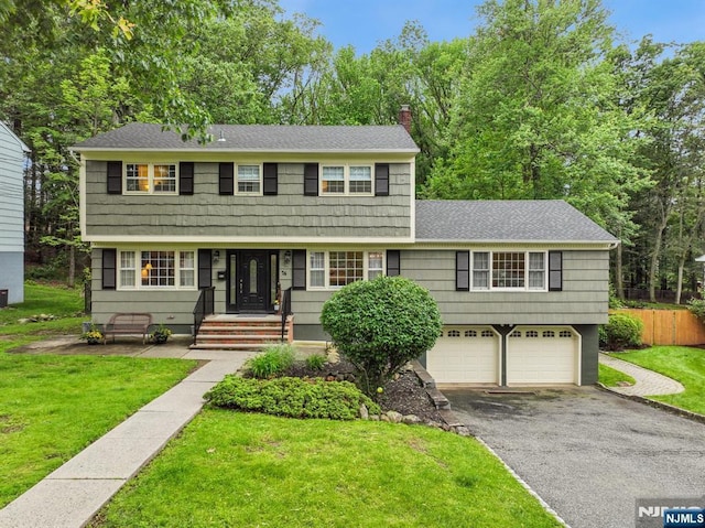 74 Park St, West Caldwell, NJ 07006 - colonial home featuring driveway, a chimney, a garage, and a shingled roof