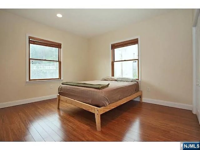1128 43rd St Unit 1, North Bergen, NJ 07047 - bedroom with multiple windows, baseboards, hardwood / wood-style floors, and recessed lighting