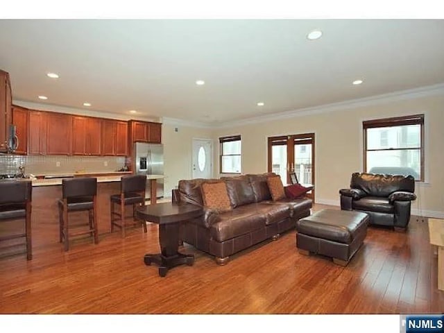 1128 43rd St Unit 1, North Bergen, NJ 07047 - living area featuring crown molding, wood finished floors, and recessed lighting
