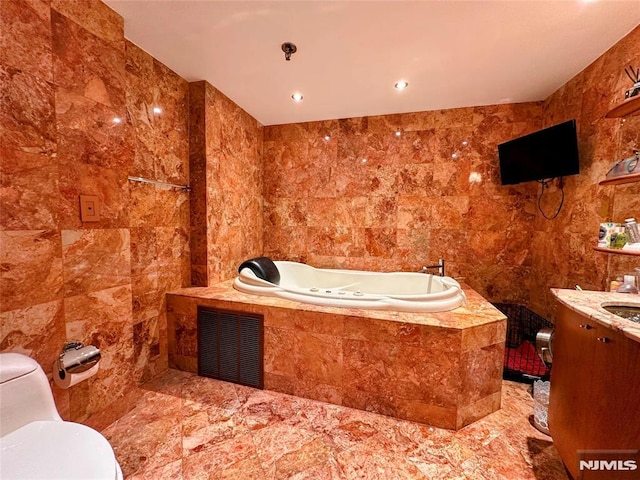1512 Palisade Ave Unit 17A, Fort Lee, NJ 07024 - full bathroom with tile walls, toilet, a garden tub, vanity, and marble finish flooring