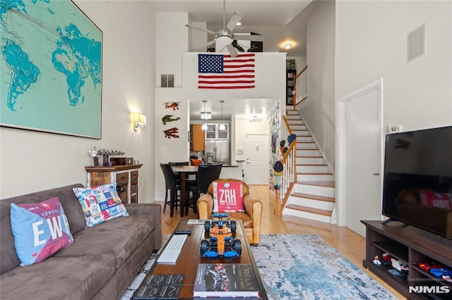 24 Ave At Port Imperial Unit 416, West New York, NJ 07093 - living area with a ceiling fan, a high ceiling, stairs, and wood finished floors