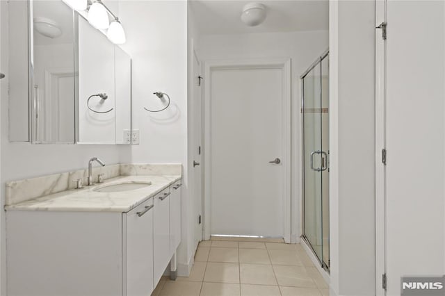 24 Ave At Port Imperial Unit 416, West New York, NJ 07093 - bathroom with vanity, a shower stall, and tile patterned flooring