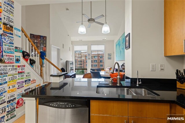 24 Ave At Port Imperial Unit 416, West New York, NJ 07093 - kitchen with dishwasher, a sink, ceiling fan, dark countertops, and brown cabinetry