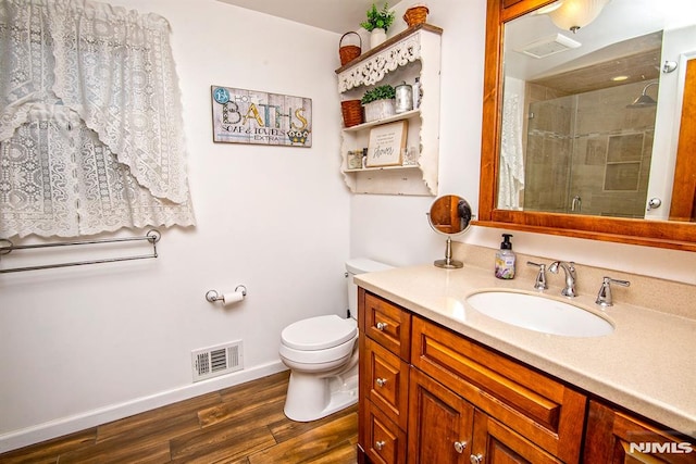 125 Virginia Ave, Dumont, NJ 07628 - bathroom featuring vanity, a shower stall, toilet, wood finished floors, and baseboards