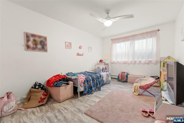 482 Joralemon St Unit G1, Belleville, NJ 07109 - bedroom featuring wood finished floors, a baseboard radiator, and a ceiling fan