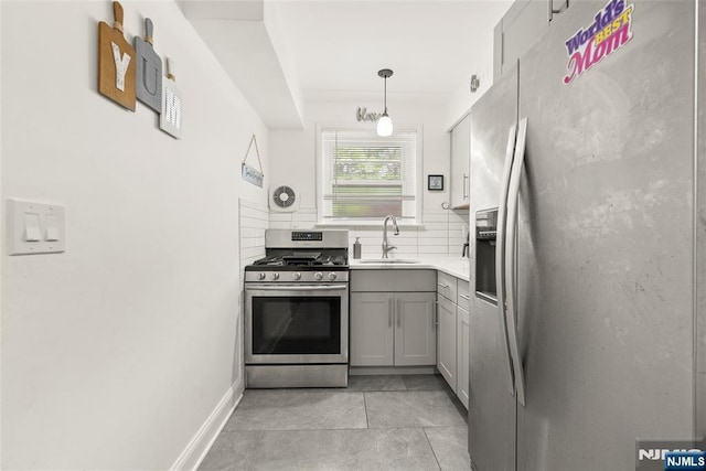 482 Joralemon St Unit G1, Belleville, NJ 07109 - kitchen featuring stainless steel appliances, a sink, gray cabinets, backsplash, and light countertops