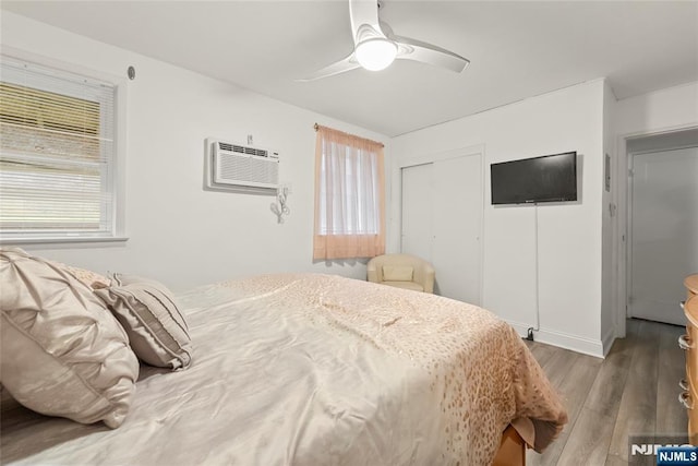 482 Joralemon St Unit G1, Belleville, NJ 07109 - bedroom featuring wood finished floors, a closet, an AC wall unit, and a ceiling fan