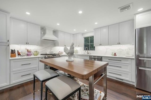 193 S Franklin Tpke, Ramsey, NJ 07446 - kitchen featuring custom range hood, appliances with stainless steel finishes, a sink, decorative backsplash, and recessed lighting